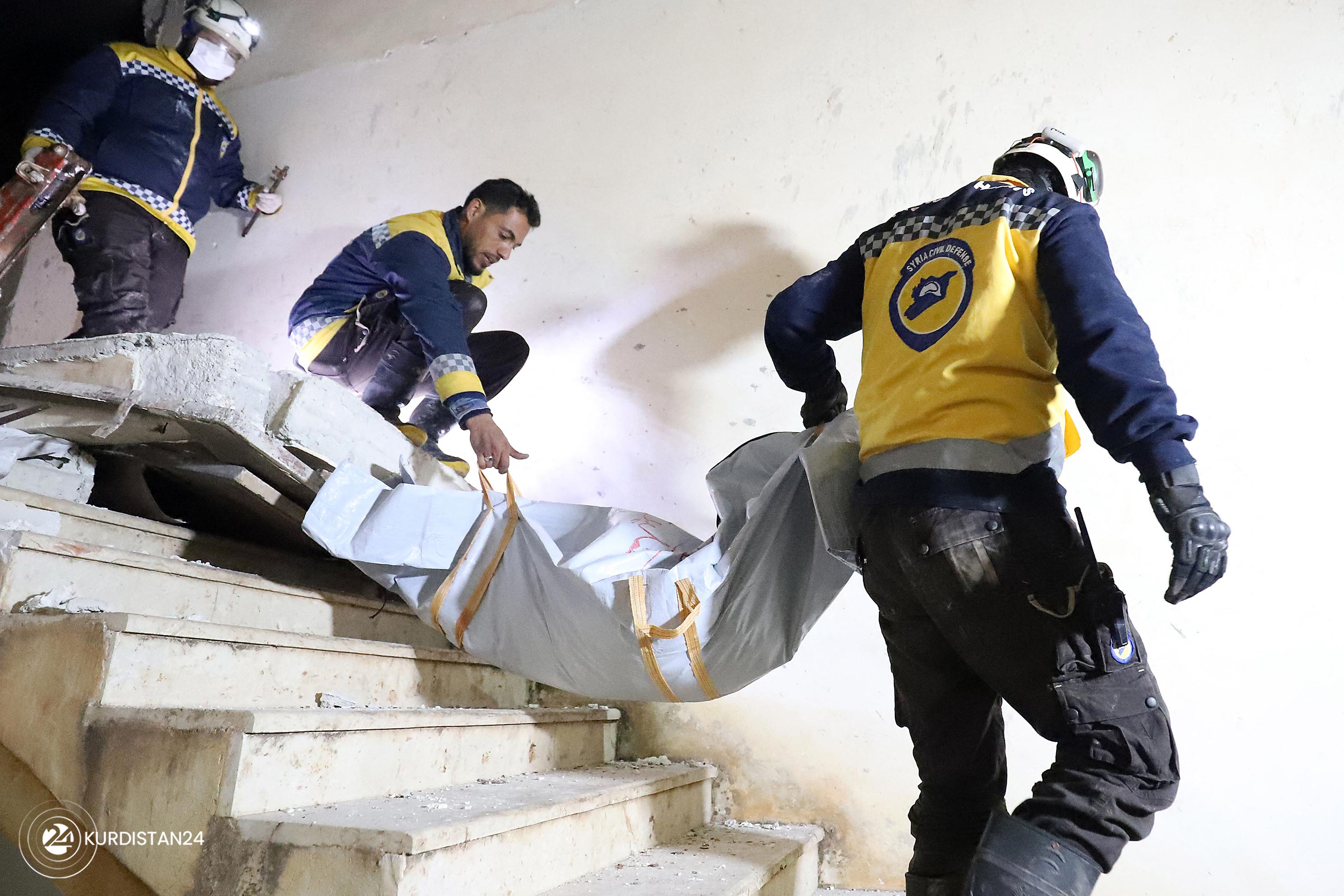 Members of Syrian civil defence known as the White Helmets, evacaute a body following the raid, Feb. 3, 2022. (Photo: Abdulaziz Ketaz/AFP)